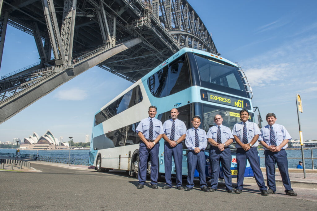 CDC AUS Bus Drivers Standing In Front Of A CDC Bus
